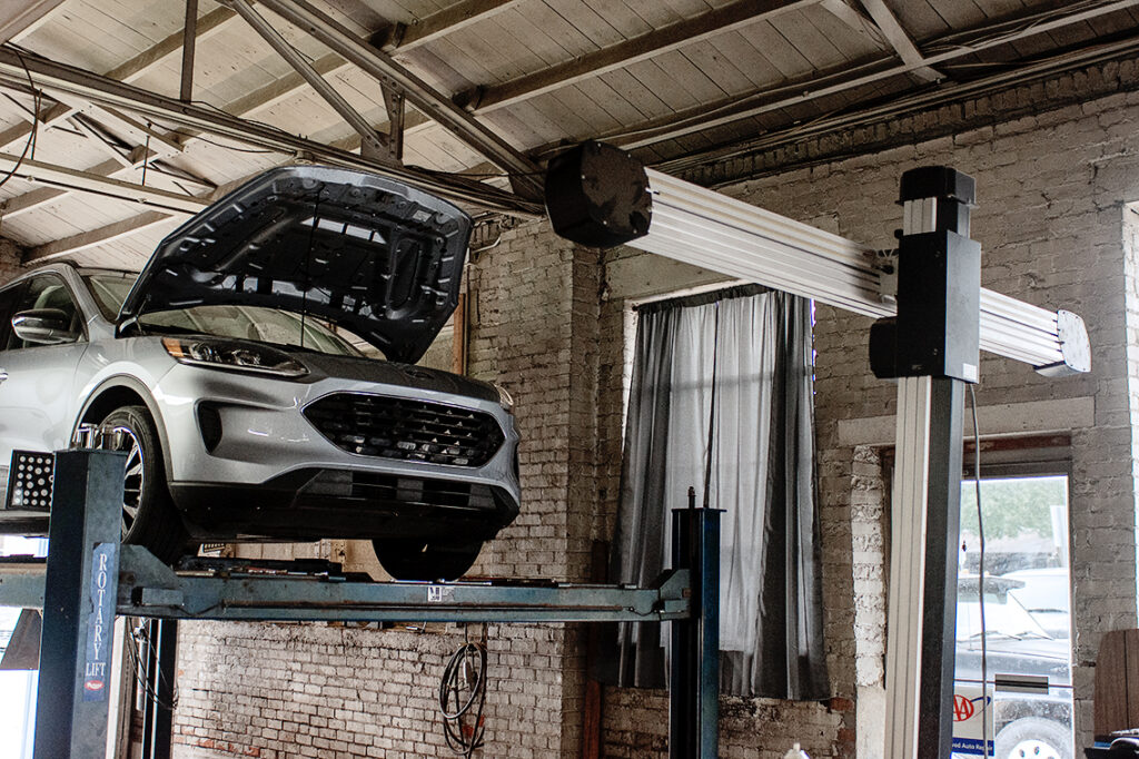 Vehicle on a lift with the hood open for heating and A/C service