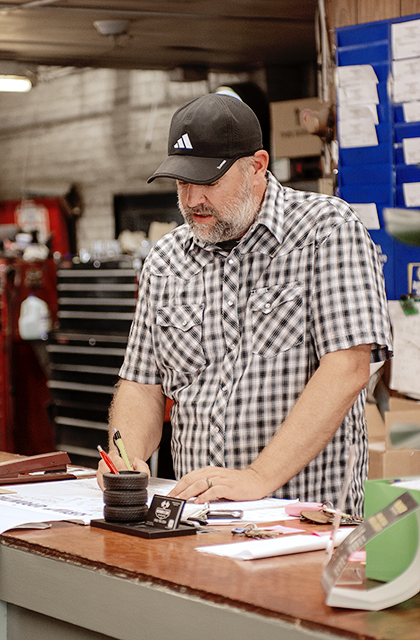 Service advisor preparing an engine repair estimate at the shop counter