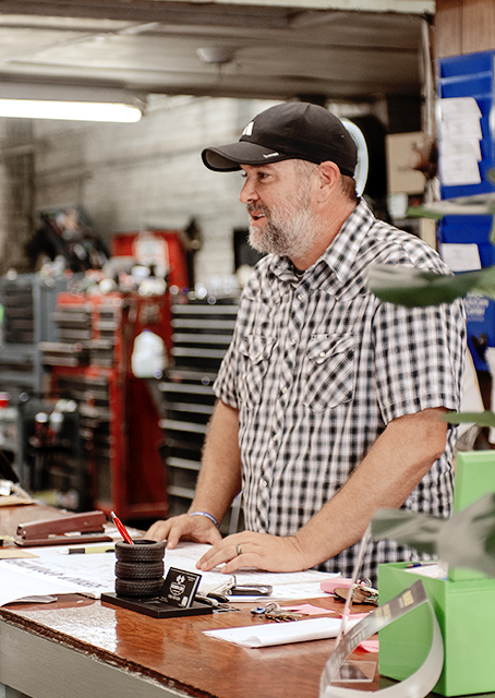 Service advisor reviewing a repair order at the Newnum & Sons Garage service desk